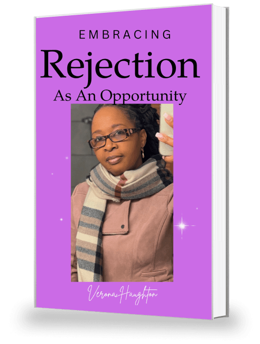 Purple book cover titled "Embracing Rejection As An Opportunity" with a photo of a person in a scarf and glasses on the front.