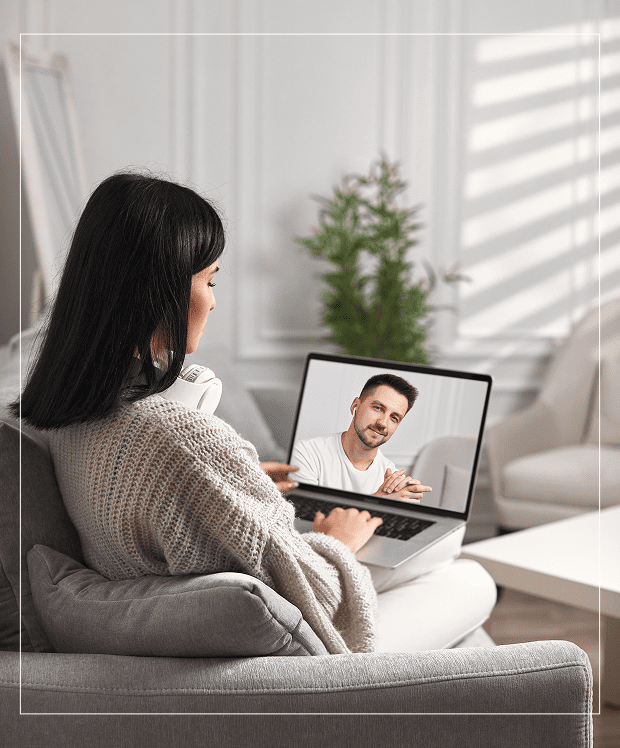 Woman video chatting with a man on a tablet at home.
